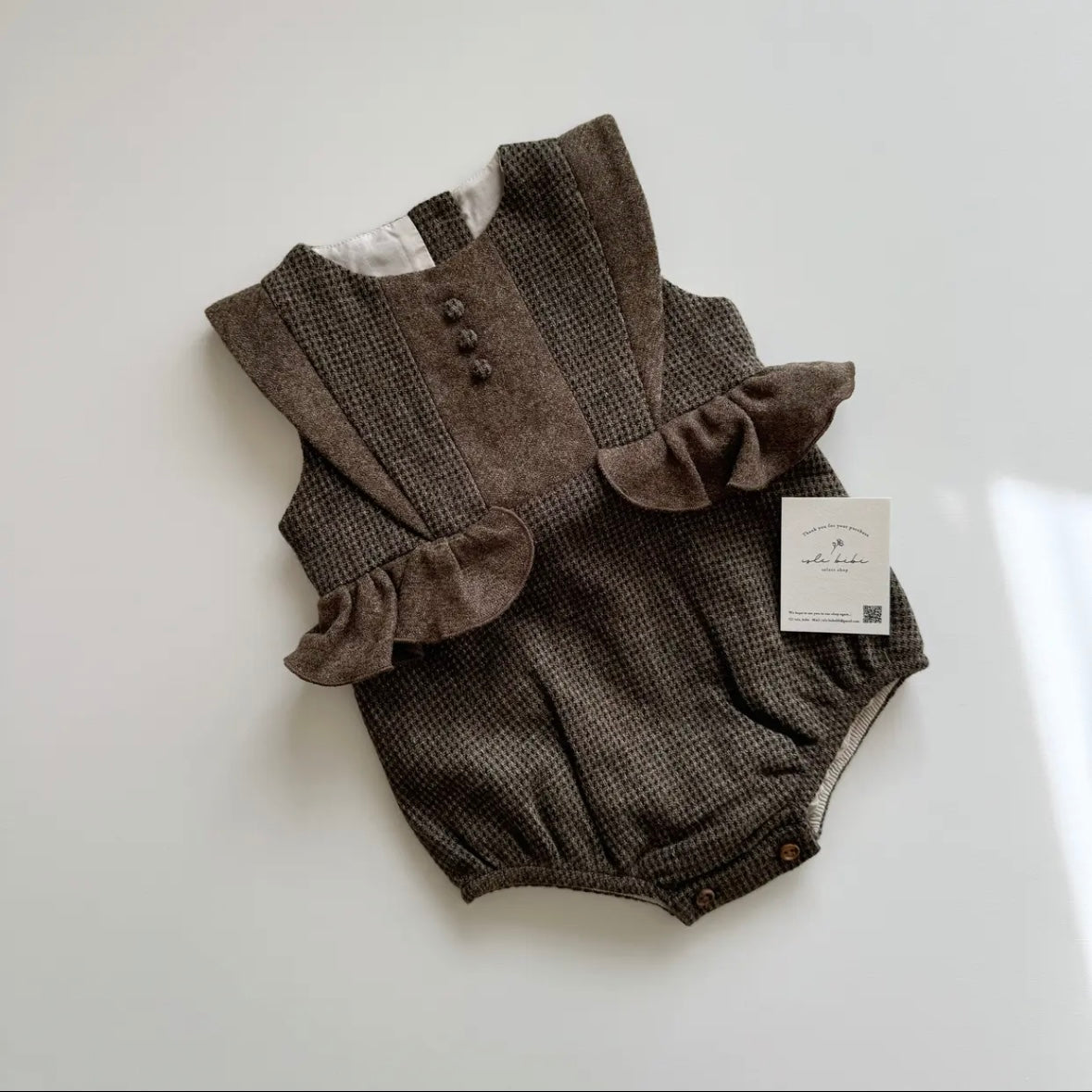 Popelin / Multi-coloured woollen romper suit with frill